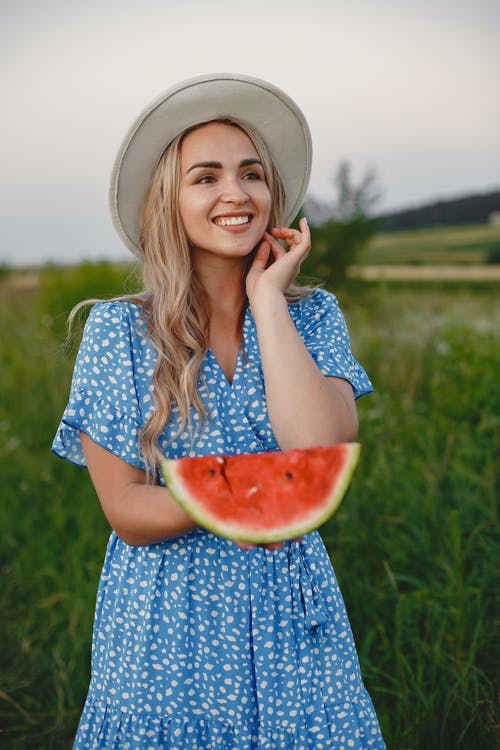 Woman Holding a Slice of Watermelon 